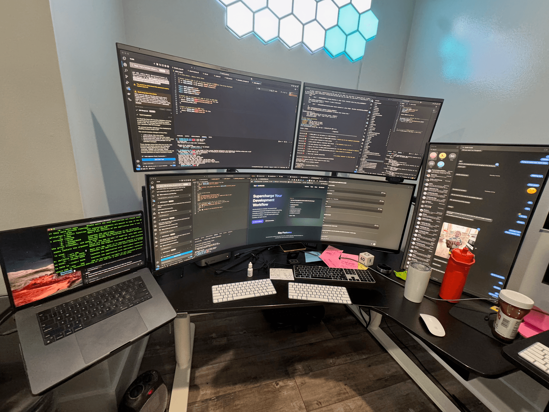 Mustafa Sualp focused on work at his desk with multiple monitors, showcasing his dedication to building Sociail