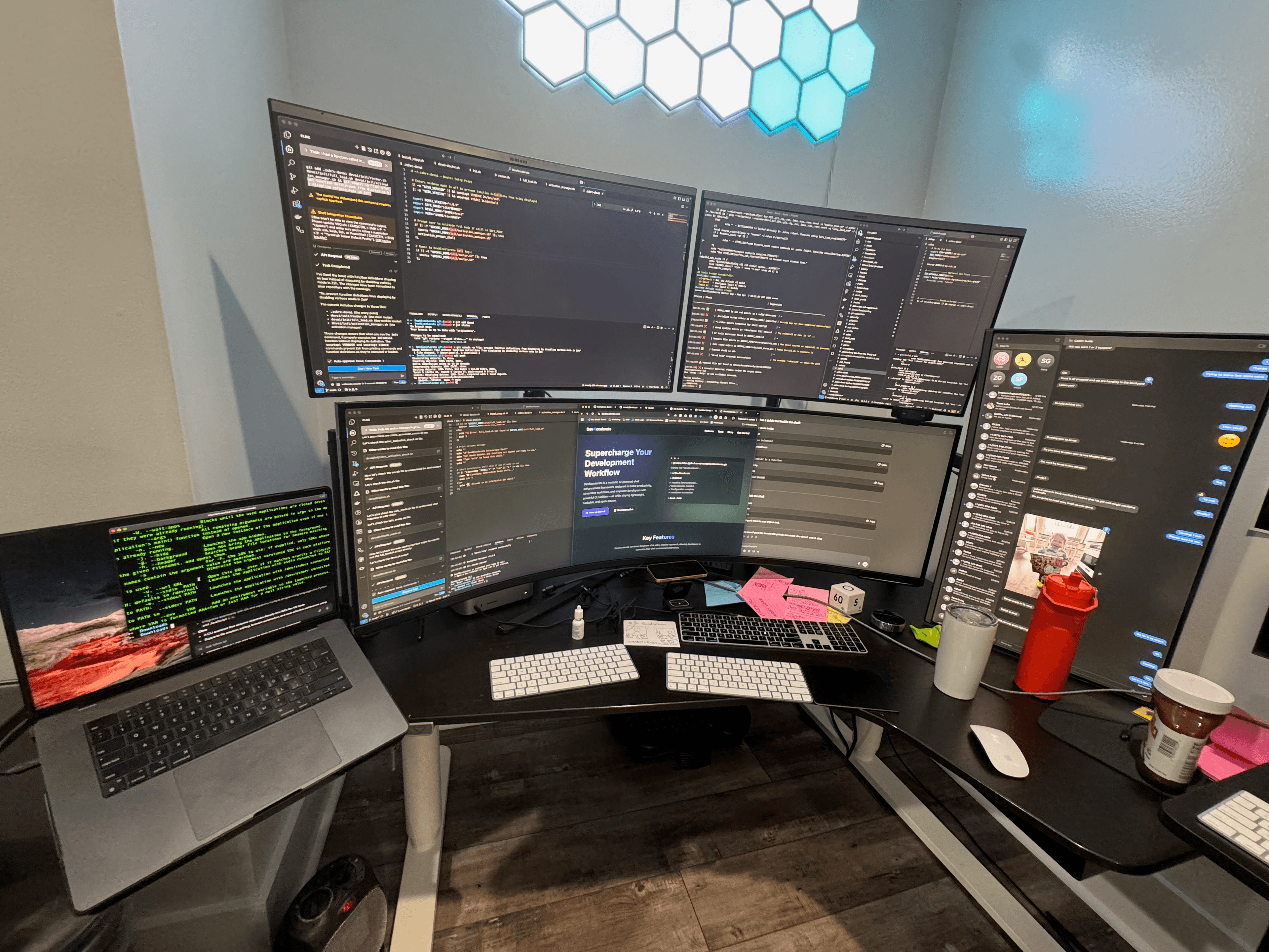Mustafa's desk with multiple screens, work notes, and a jar of Nutella.
